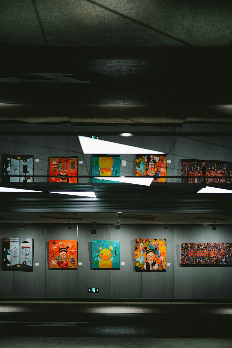 Colorful pop art paintings displayed on a gallery wall.